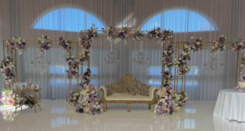 gold lattice arch with lilac artificial flowers