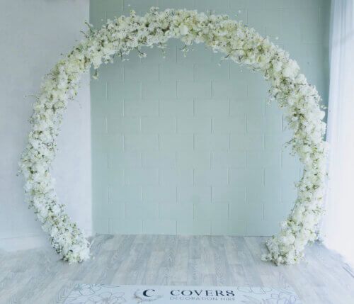 White cherry blossoms on a circle arch.